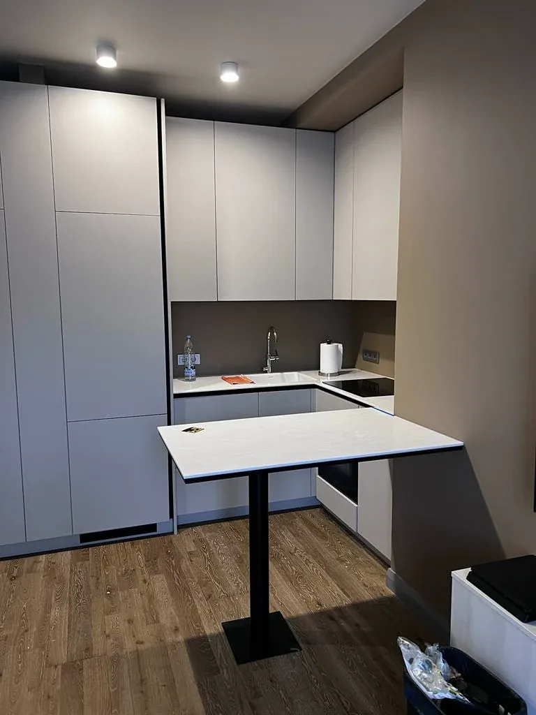 Turnkey custom furniture project in Compact Apartment Kitchen Custom Cabinets by RPGroup